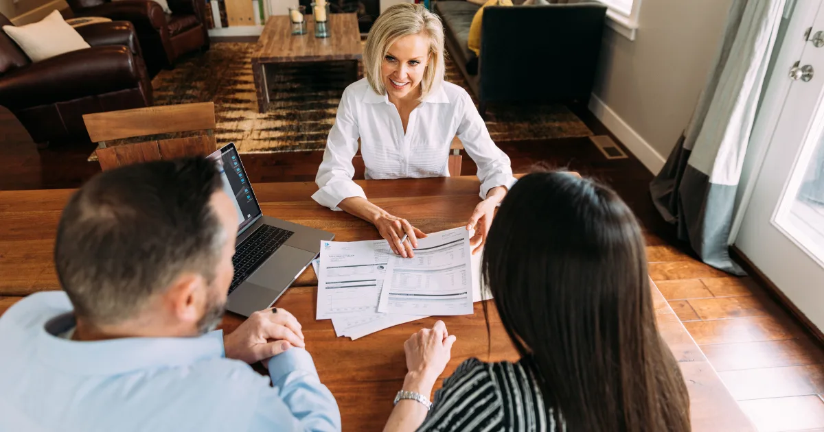 Mortgage broker comparing lender options with homeowners